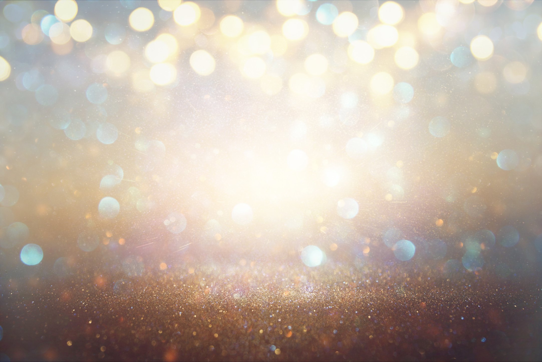 glitter vintage lights background. light silver and gold. defocused